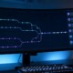 Workflow Git d'équipe avec branches IA-assistées et review humaine sur un monitor de développeur